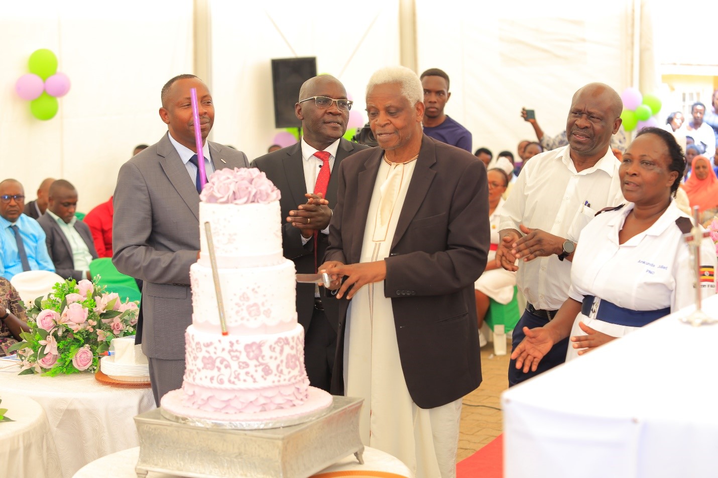 Prof Iraka Owange, the MRRH Board chair (‘in kanzu’) led the MRRH & MUST staff during the cake cutting ceremony. This was performed to thank God for rewarding the Hospital Director a gift of life.