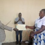 Deputy RDC Okidi James Cosmas recieving the certificate of award by LC3 CCHAIRPERSONS