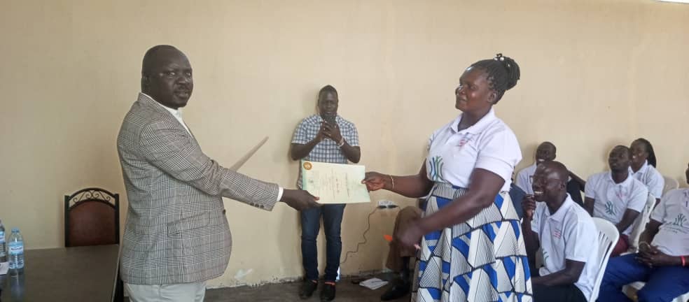 Deputy RDC Okidi James Cosmas recieving the certificate of award by LC3 CCHAIRPERSONS