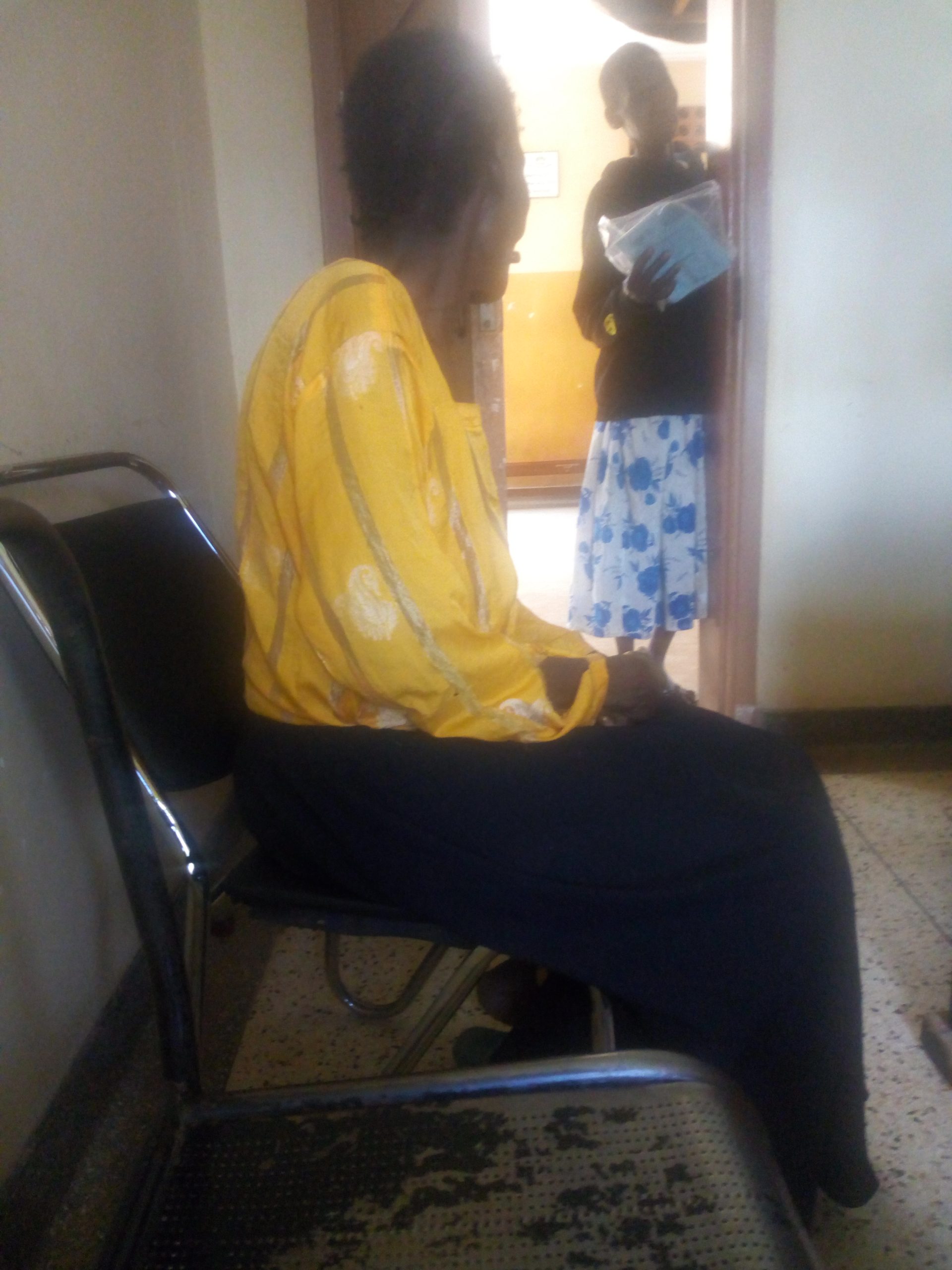 Judith Abur 67 years old a caretaker interacting with another caretaker while at the hospital. Photo by Wilfred Okot