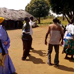 Oyuku village locals organizing dances to fund raise for the school during Action Aids intervention. Behind is the structure of the school founded by the parents