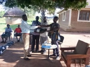 Chief Lugai II hnading over the exams to the teachers from Ker Kwaro Pajule Palace Chief Lugai II hnading over the exams to the teachers from Ker Kwaro Pajule Palace