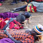 A group of the Karimojong men sleeping while using a stool as their pillows in Moroto (photo by Steven Ariong)