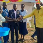 Minister Ogwangs team handing 5m to the organising commitee