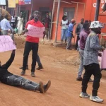 The youth who camped at the King Star building in Hoima city demanding that the owner paves way for construction of the road Photo by Peter Atugonza.