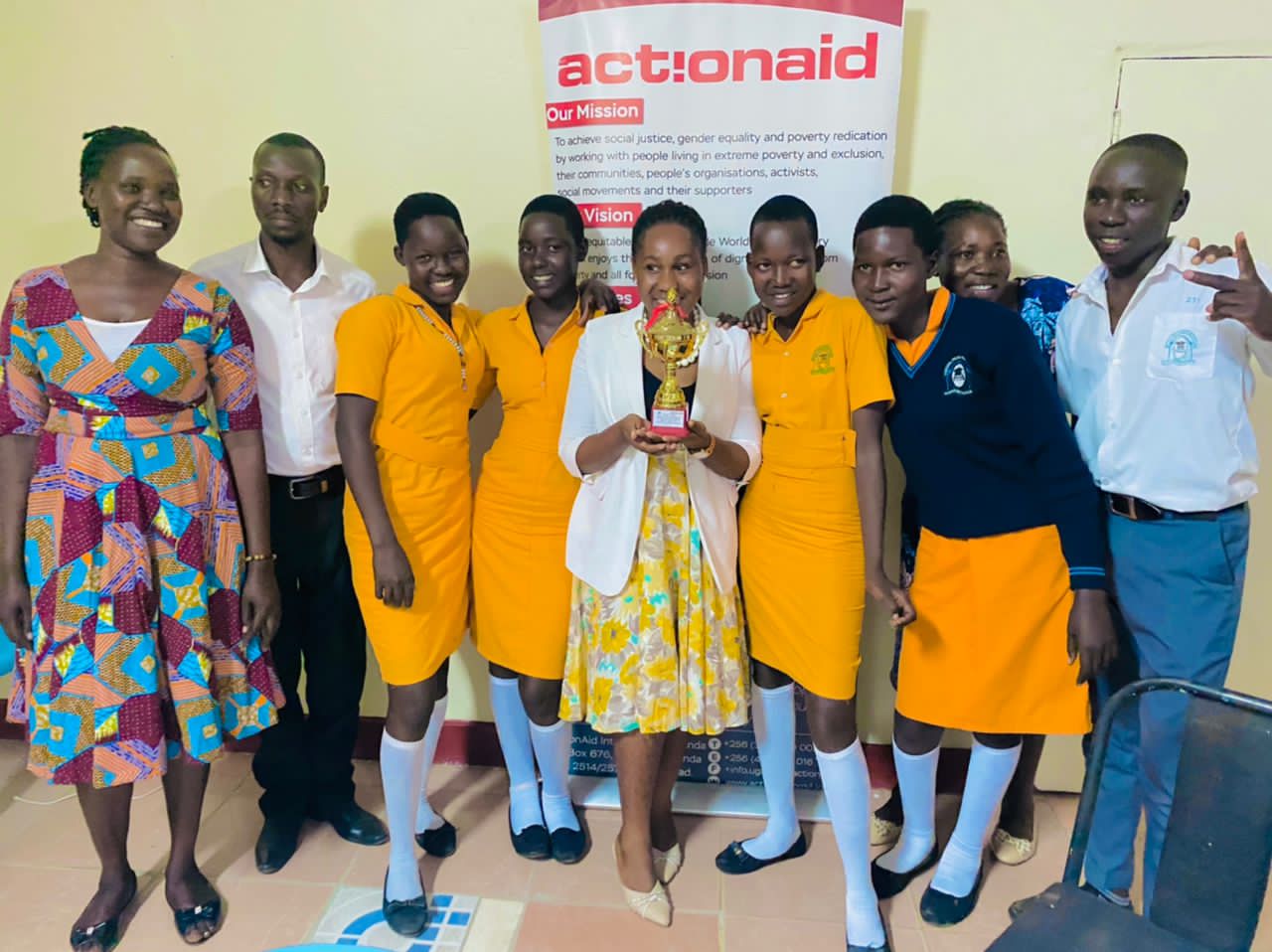 Toroma peas students after winning take a photo with a secretery for eduction in katakwi DLG