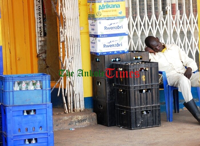 Try plan B if there are no customers A trader in Moroto takes nap next to his creats of soda and beer after waiting customers for long in Moroto Municipality (photo by Steven Ariong) (1) (1)