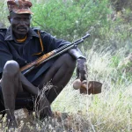 Armed Karimojong pastoralist grazing his animals along Karamoja Turkana border in Moroto district photo by Steven Ariong