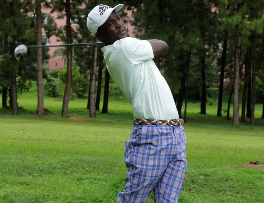 David Kamulindwa Amooti follows the flight of his ball Golf Uganda
