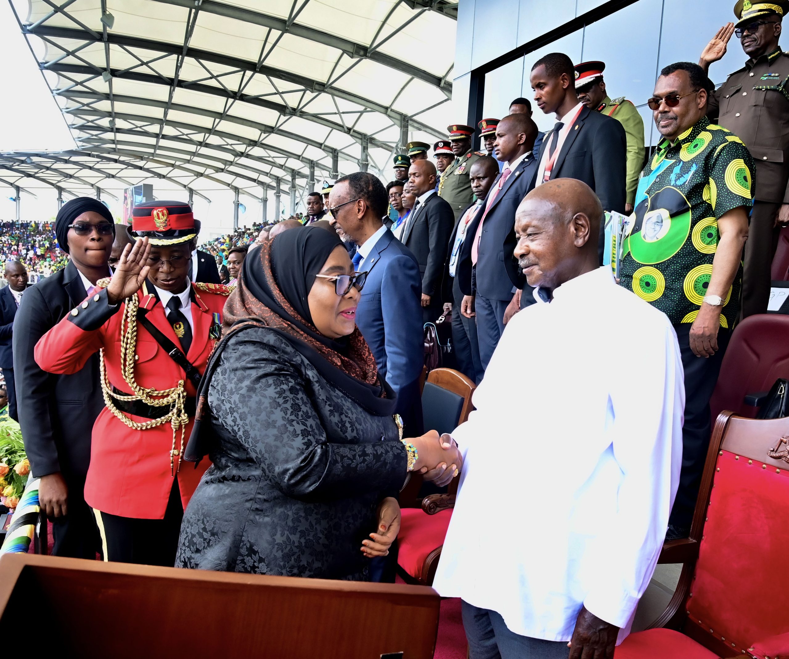 President Museveni chats with President Samia Suluhu of Tanzania during the 60th anniversary of the Zanzibar revolution in Zanzibar on Friday. PPU Photo (2)