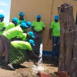 ater user committee of Kacheri opening water on Friday during the commisioning of piped water in Kacheri (photo by Steven Ariong)