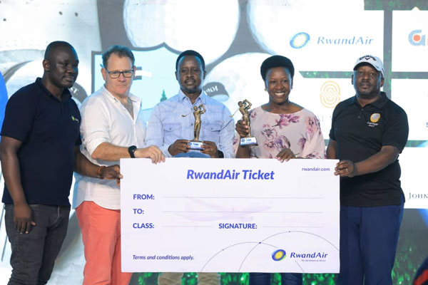 Peace Kabasweka and Perez Muhwezi receive there dummy ticket from RwandAir official together with the CEO of I and M Bank Robin Bairstow together with Katogo Golf Series captain Elly Mukasa