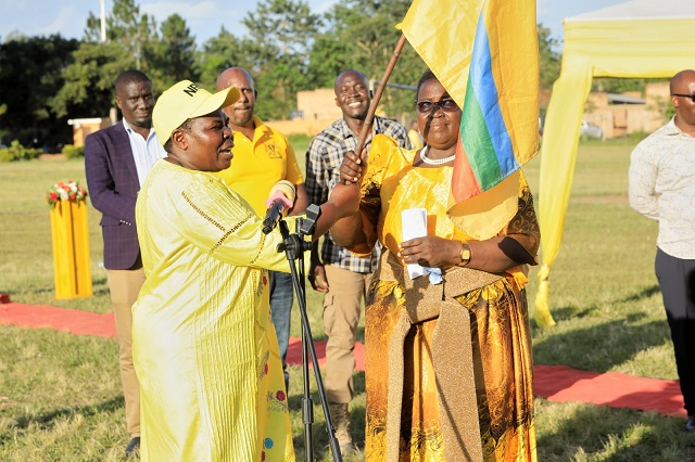 Rose Namayanja Nsereko hands over the NRM flag to Janet Adongo Elau Dokolo