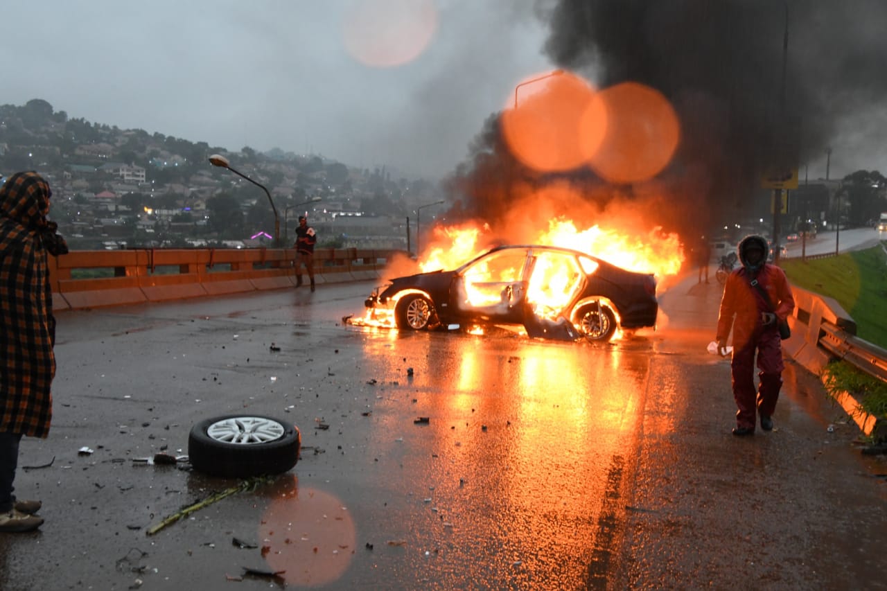 A morning collision at the Namboole flyover led to a car catching fire, injuring three people amid rainy conditions in Kampala.